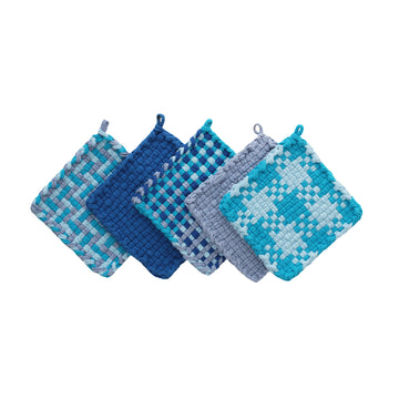 Five patterned and solid color potholders made of loops in shades of blue